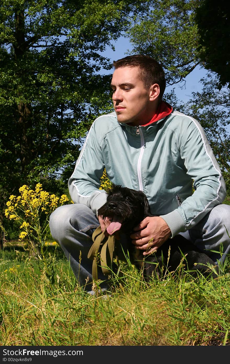 Young guy with black dog. Young guy with black dog