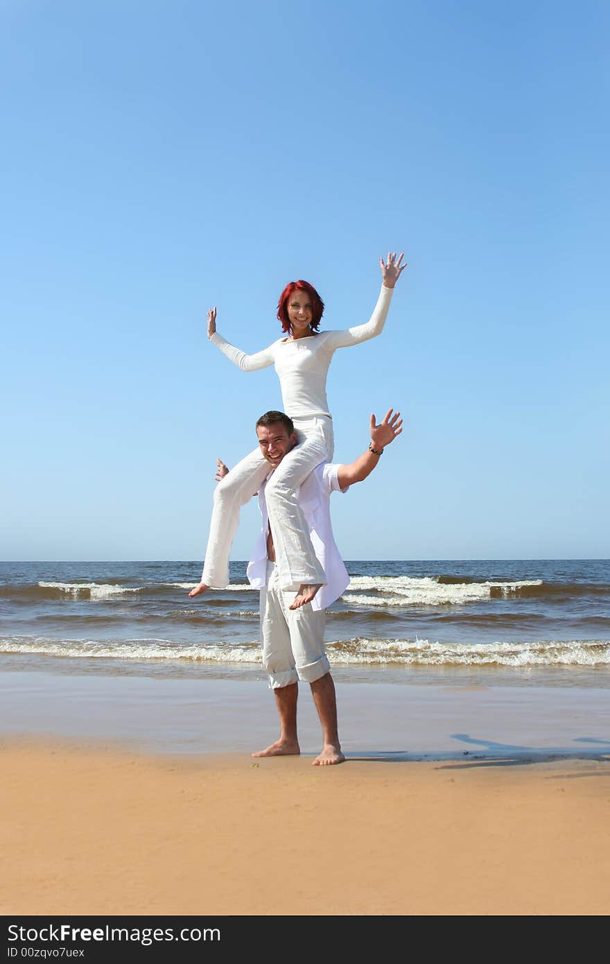 Beautiful yound couple relaxing on the beach. Beautiful yound couple relaxing on the beach