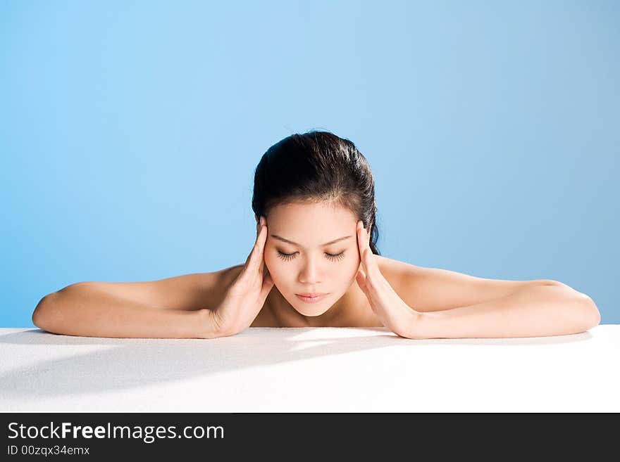 Young woman with both hands on her forehead