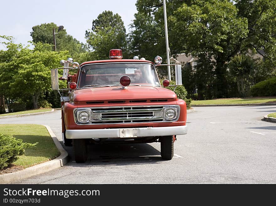 An old vintage fire truck in a parking lot