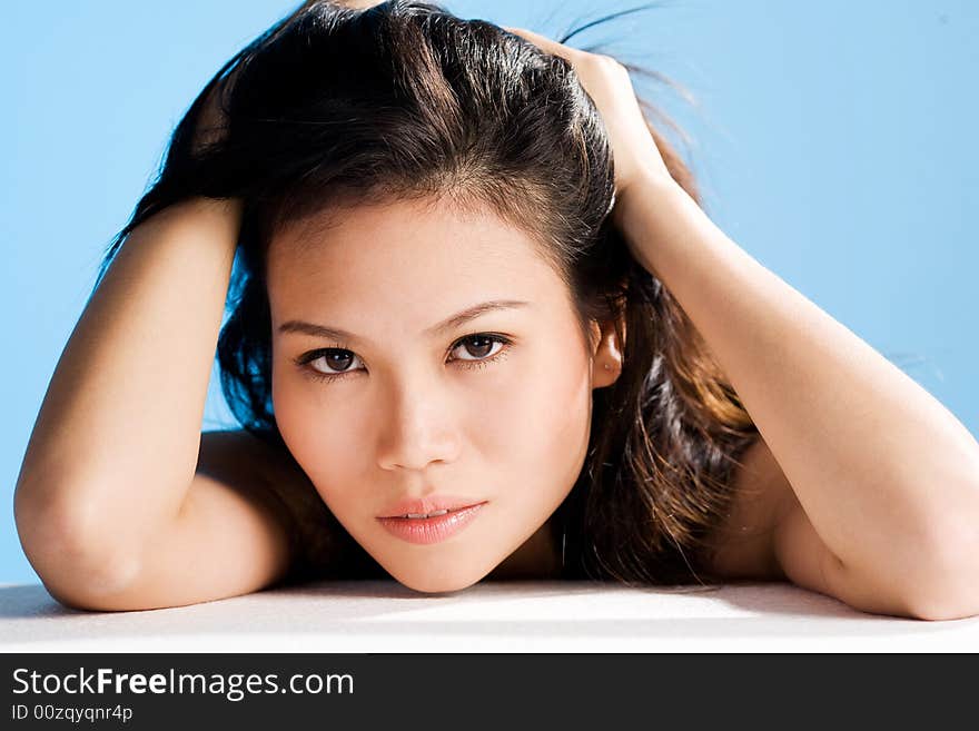 A beautiful asian woman's face with an engaging gaze. A beautiful asian woman's face with an engaging gaze