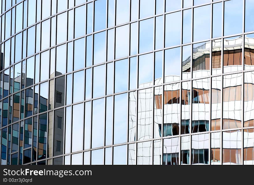 Modern corporate buildings reflected in office glass. Modern corporate buildings reflected in office glass.