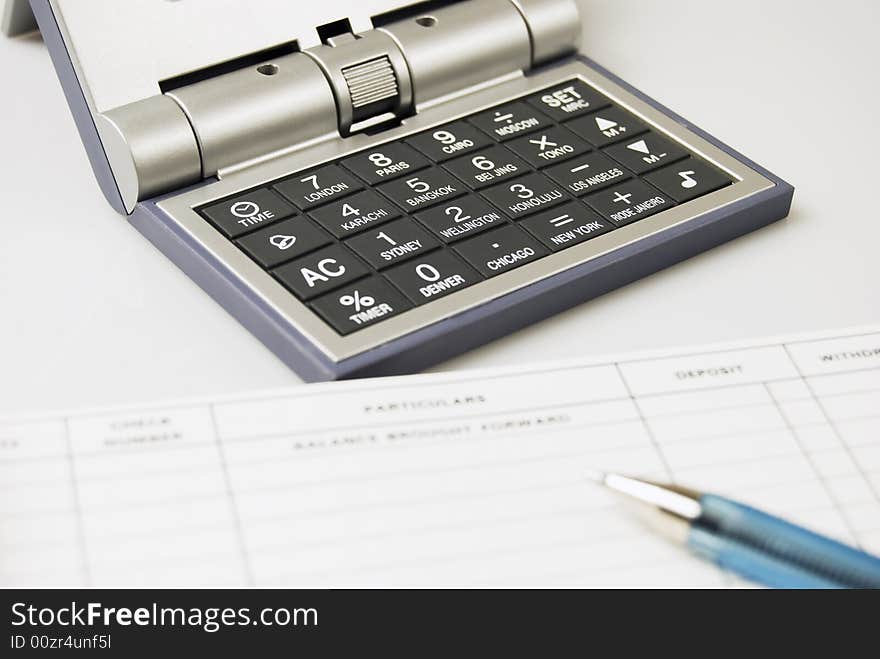 Calculator and alarm clock in one, a check, and a ballpen. Calculator and alarm clock in one, a check, and a ballpen