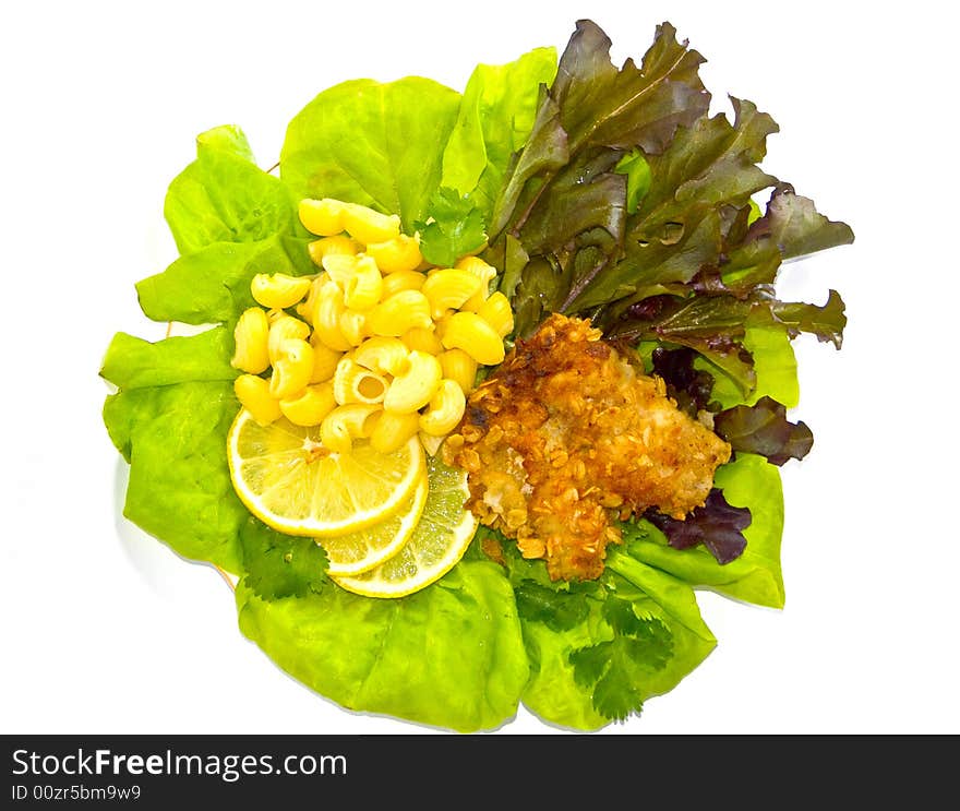 The image of macaroni, of a fish and slices of a lemon close up. The image of macaroni, of a fish and slices of a lemon close up