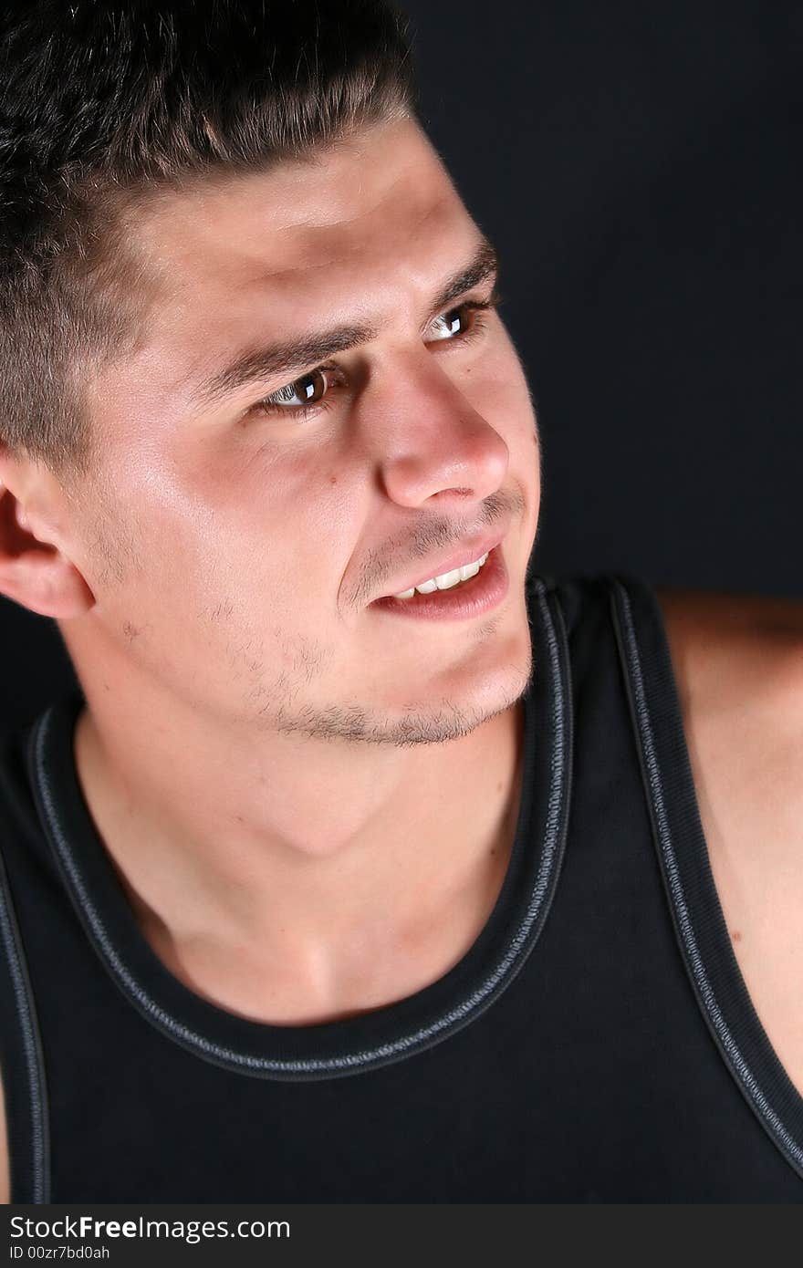 Male model in studio against a dark wall