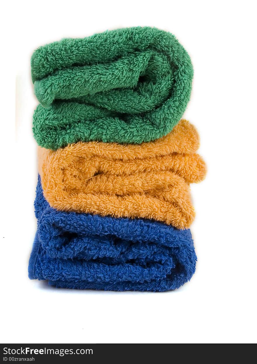 Blue, orange and green towels on white background. Blue, orange and green towels on white background