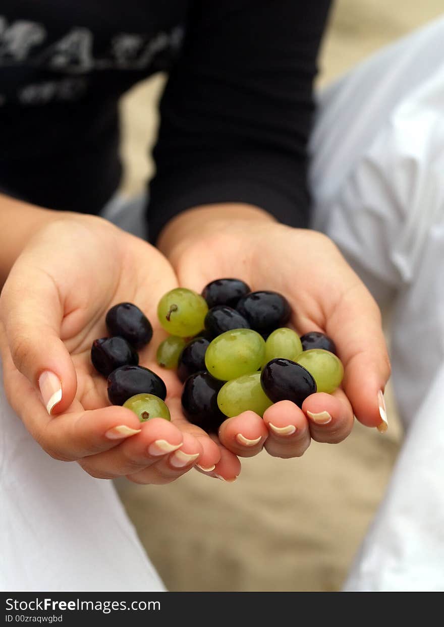 Woman take some grapes in her hands. Woman take some grapes in her hands