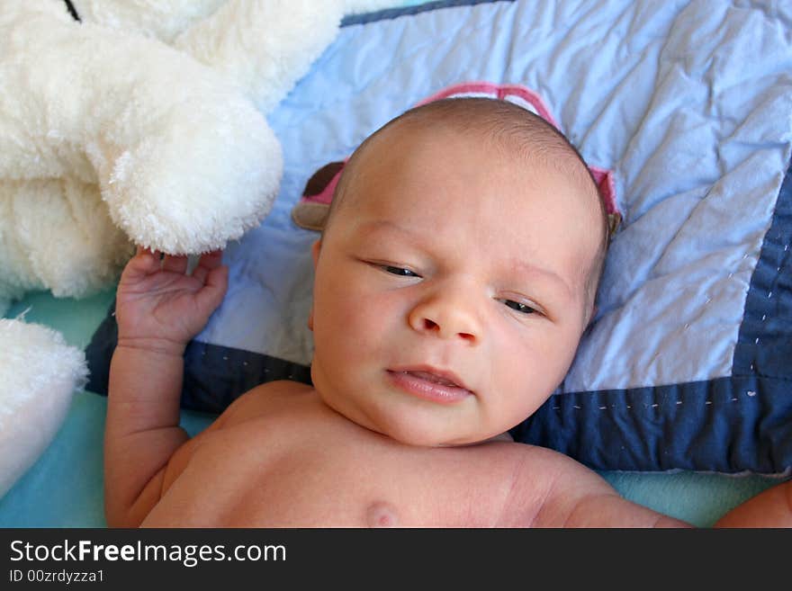 Week old baby boy on a blue blanket early in the morning. Week old baby boy on a blue blanket early in the morning