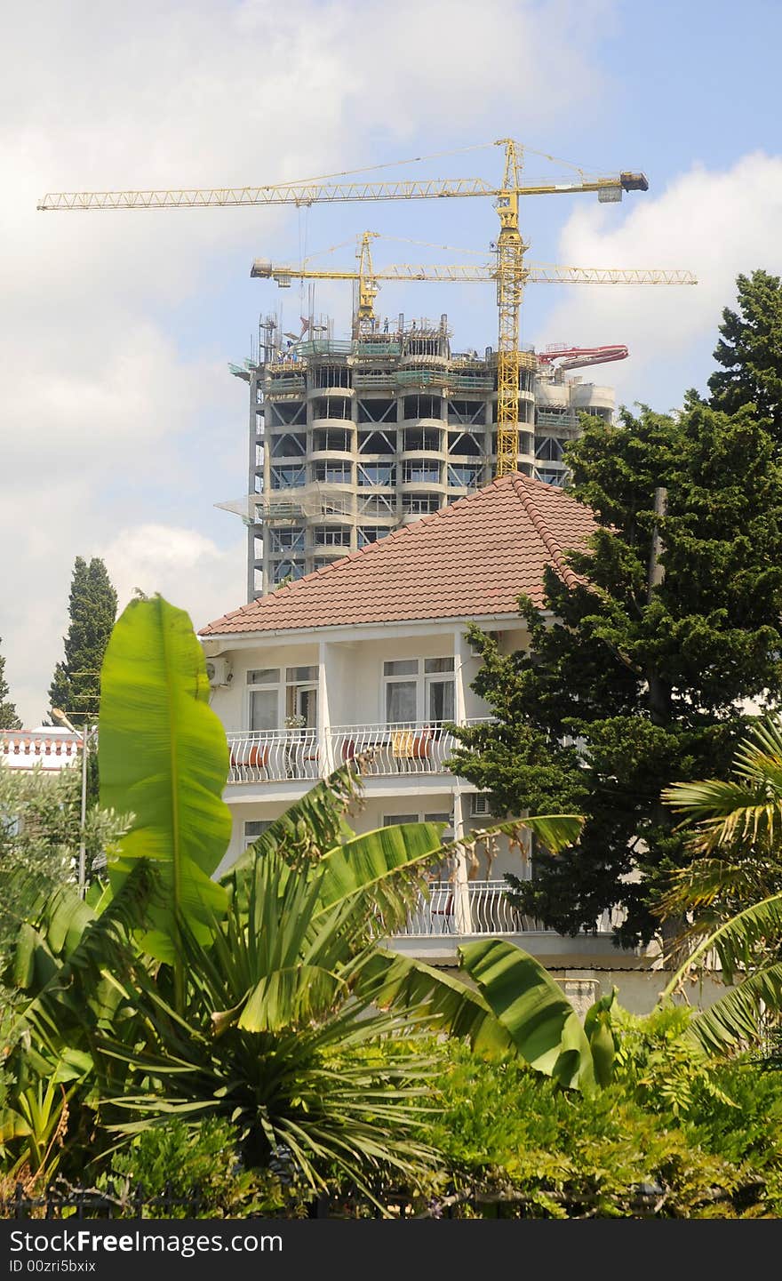 Building and crane and many trees