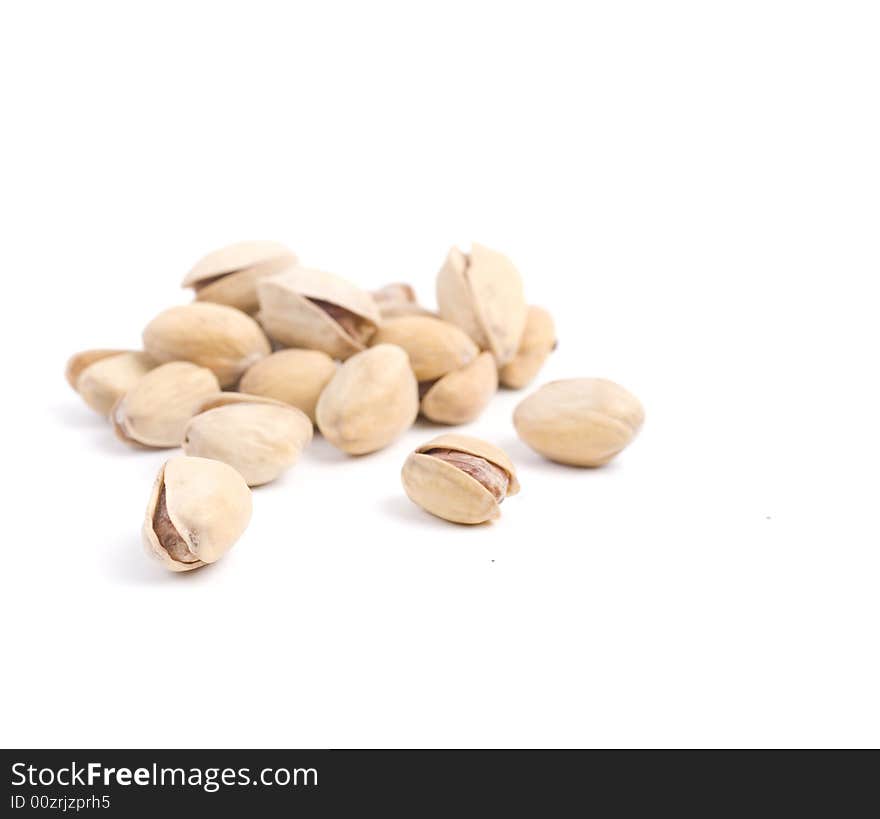 Solted pistachio nut at white isolated background