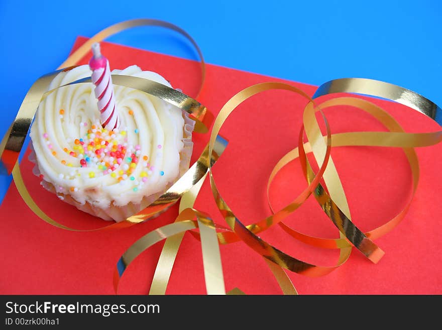 Birthday Cupcake with one candle and gold ribbon