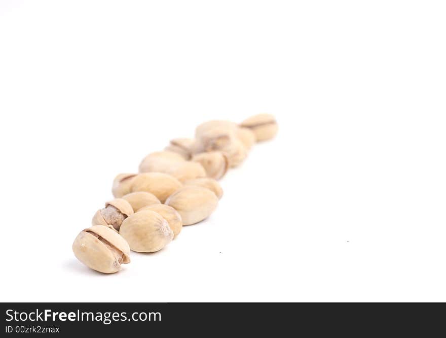 Solted pistachio nut at white isolated background