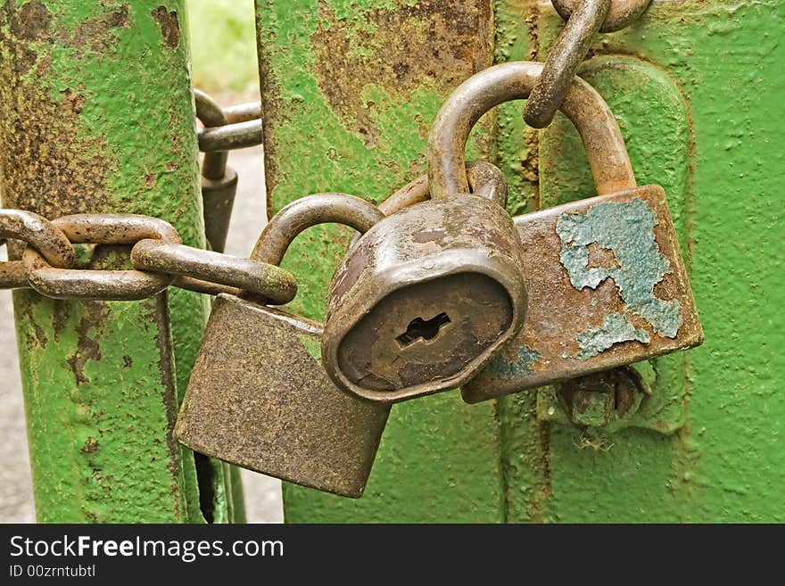 Three rusty padlocks with a chain. Three rusty padlocks with a chain