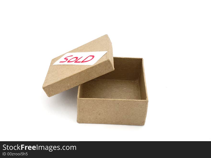 Cardboard box with sold label. Cardboard box with sold label.