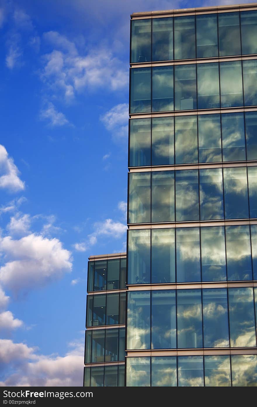 Blue sky reflection on glass modern building