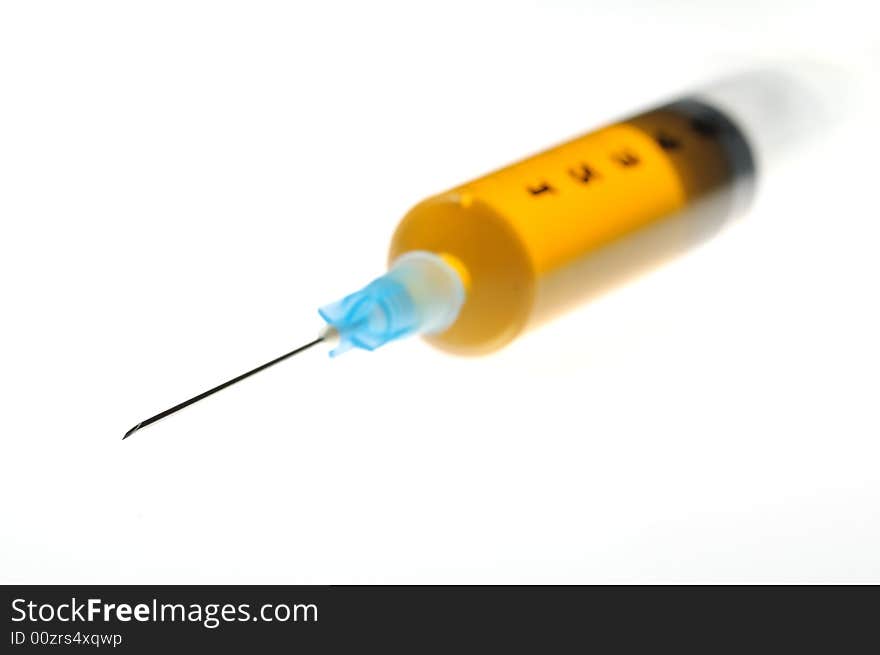 An isolated syringe whit yellow liquid. An isolated syringe whit yellow liquid