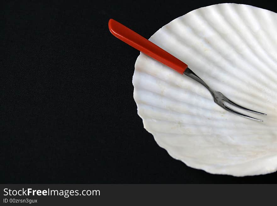 Special small fork and shell plate for seafood starters. Special small fork and shell plate for seafood starters