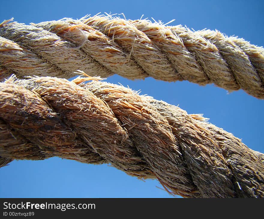 Old fishing boat rope against blue sky