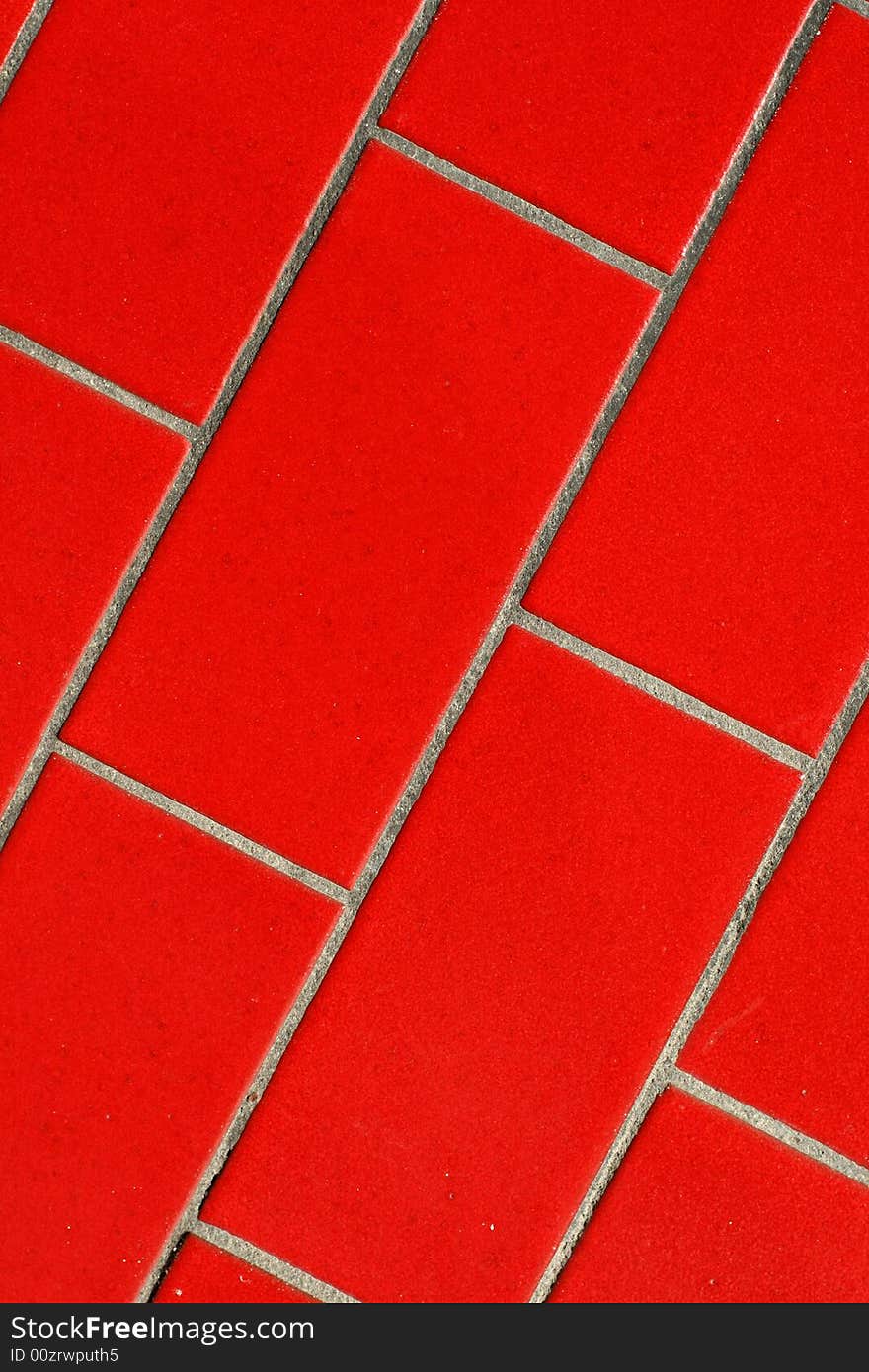 A close up of a red tiled wall.