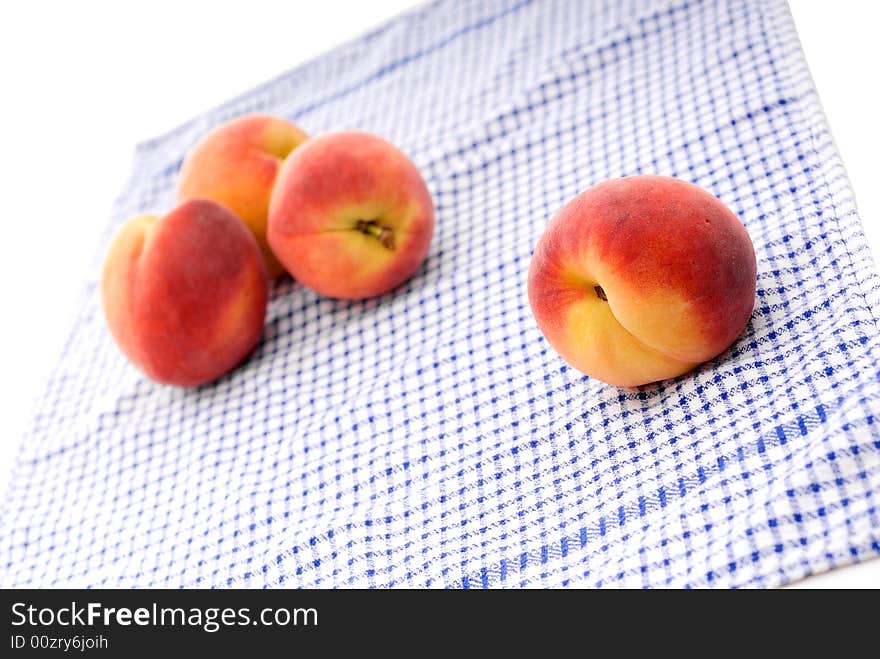 Fresh peaches on a kitchen towel