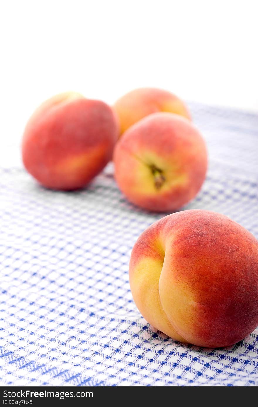 Fresh peaches on a kitchen towel