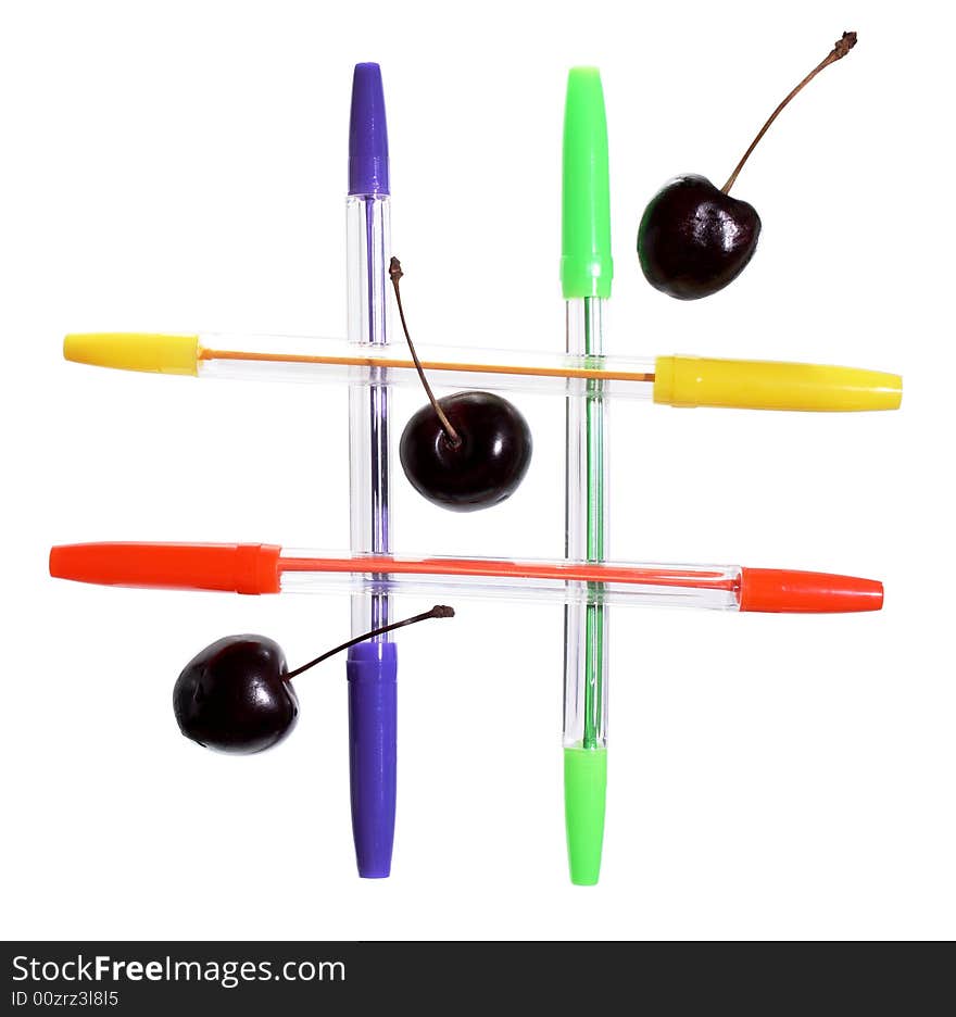 Four colored  ballpoint pens and three cherries on white background. Four colored  ballpoint pens and three cherries on white background