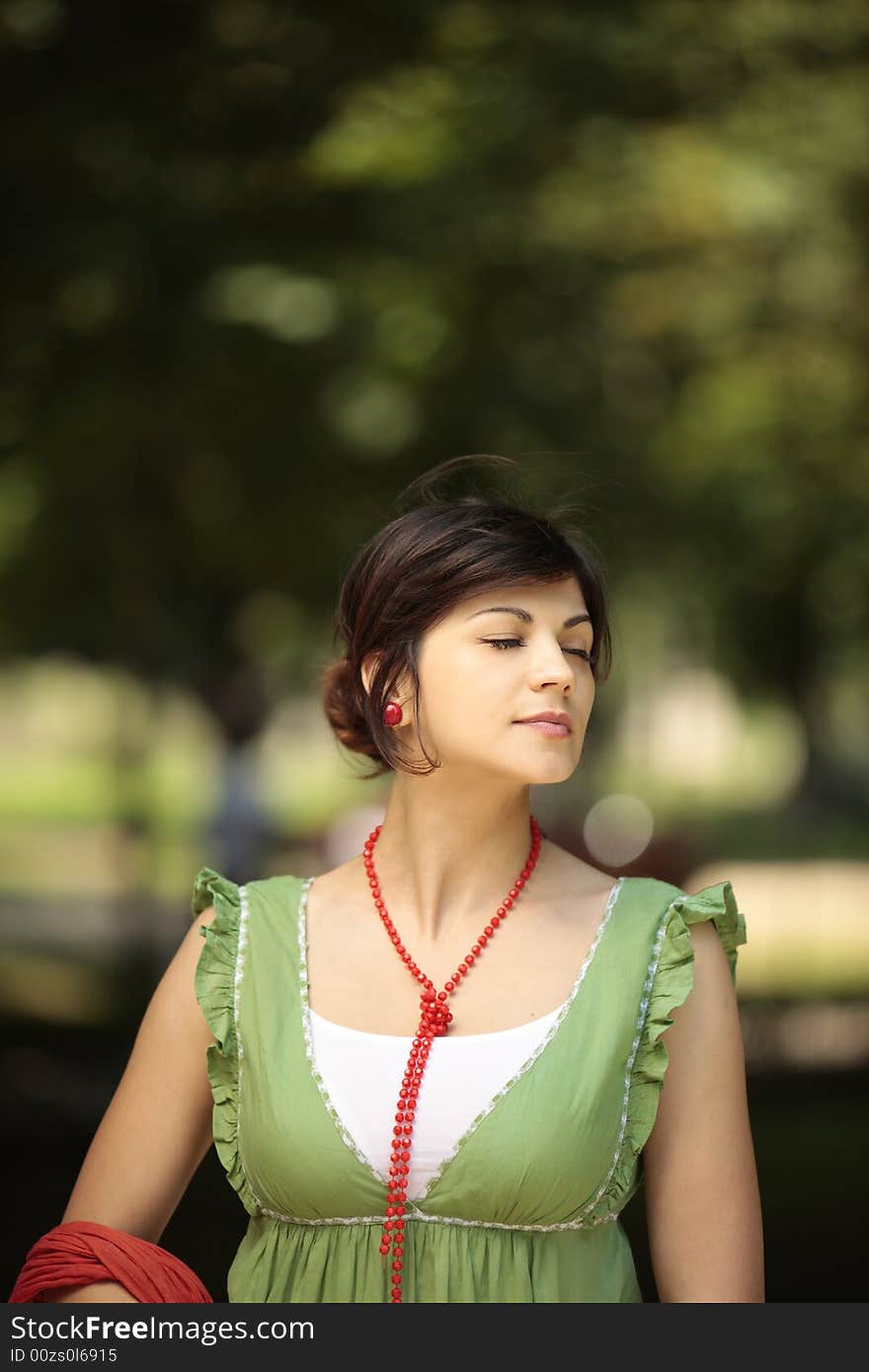 Young lady in nature with her eyes closed with a peaceful face. Young lady in nature with her eyes closed with a peaceful face