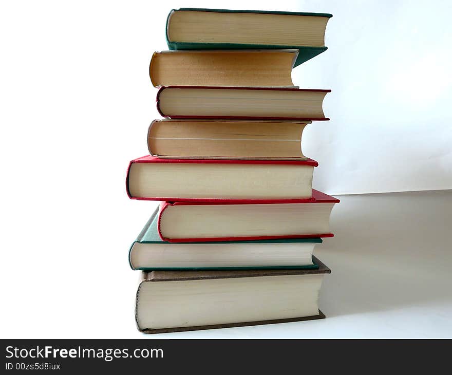 Eight books liing on each other on a white background. Eight books liing on each other on a white background