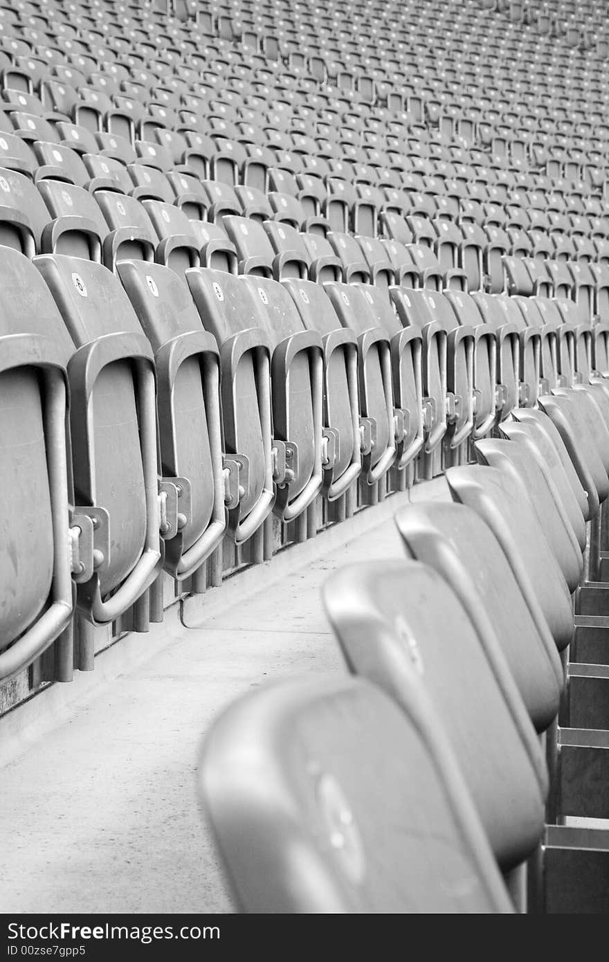 Rows of grey empty stadium seats