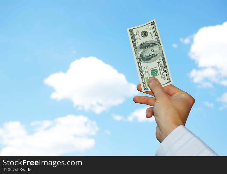 Money in hand  isolated on sky background