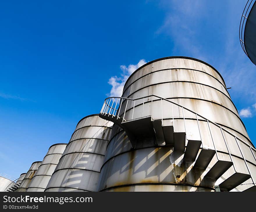 Spiral staircase up a industrial cylindrical tank to access its roof. Spiral staircase up a industrial cylindrical tank to access its roof