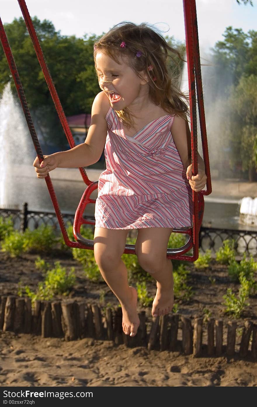 Happy smiling little girl having fun on swing. Happy smiling little girl having fun on swing