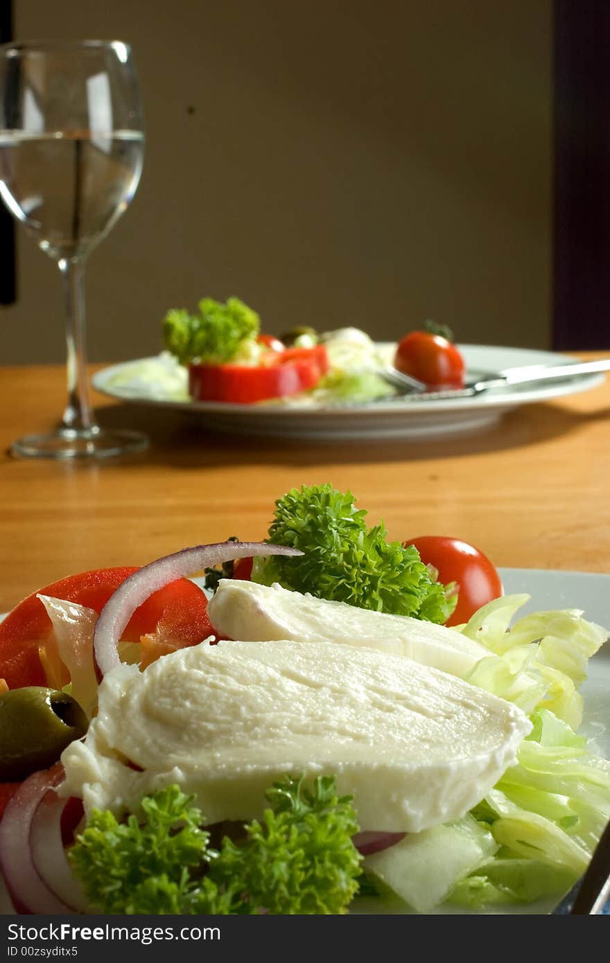 Table setting, including an Italian salad. Table setting, including an Italian salad