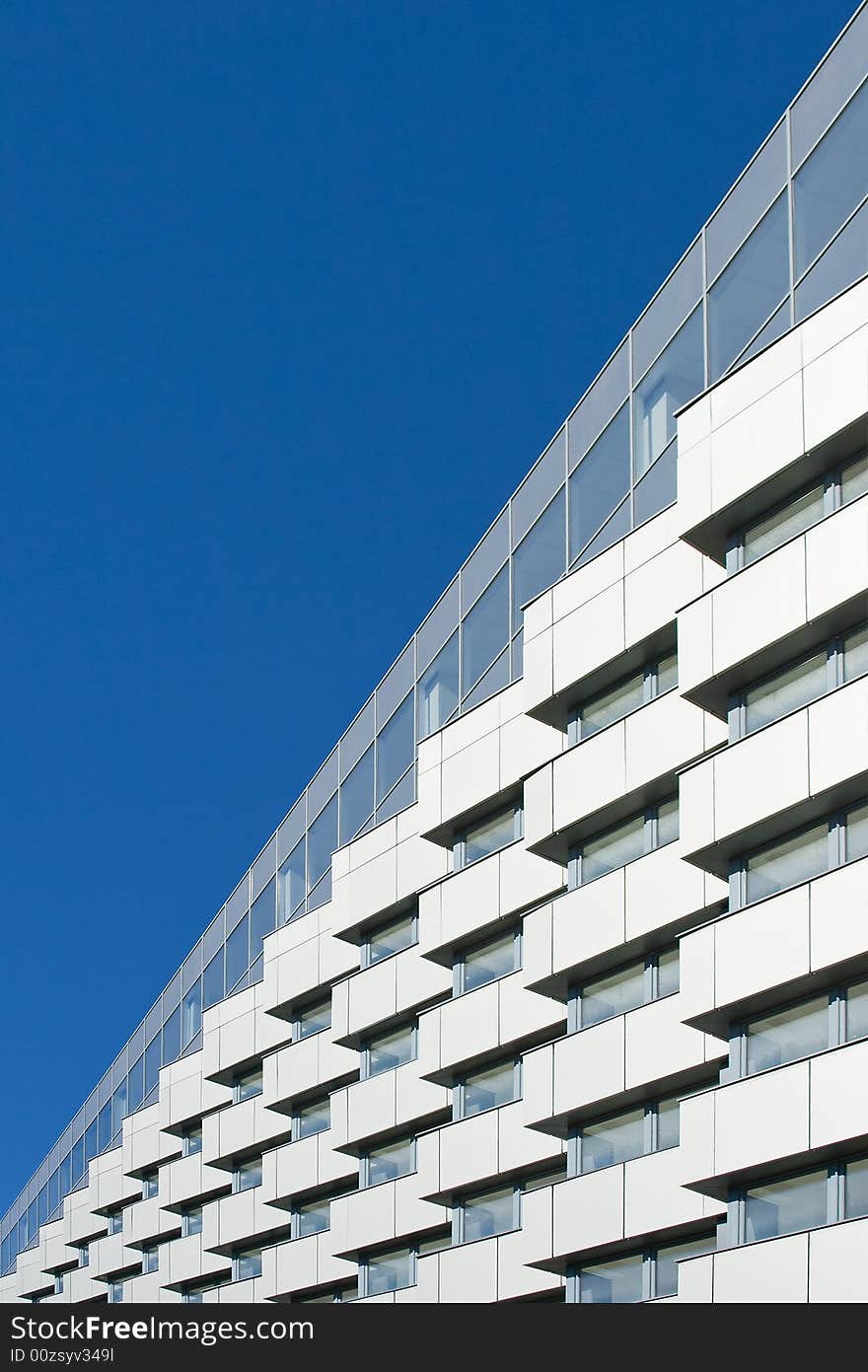 Modern building on a background of the blue sky. Modern building on a background of the blue sky