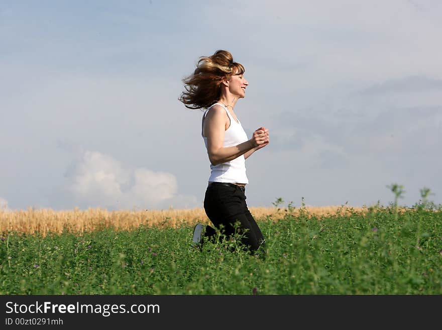 A beautiful girl running on the field