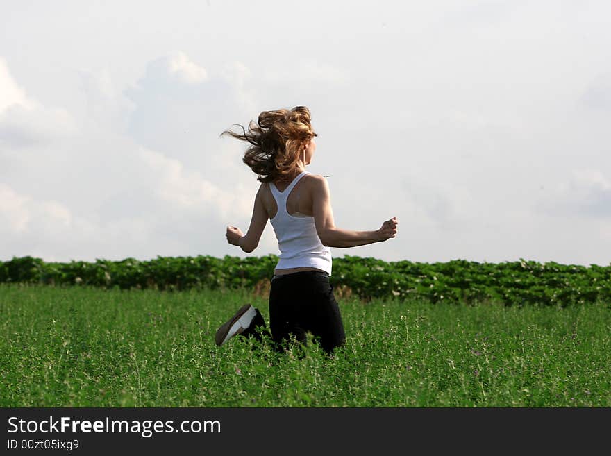 A beautiful girl running on the field