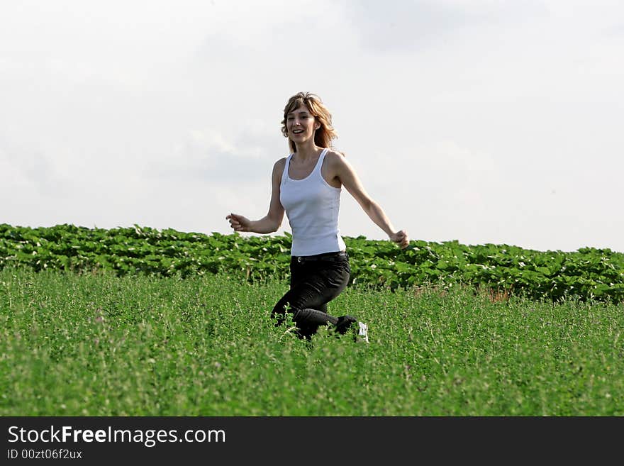 A beautiful girl running on the field