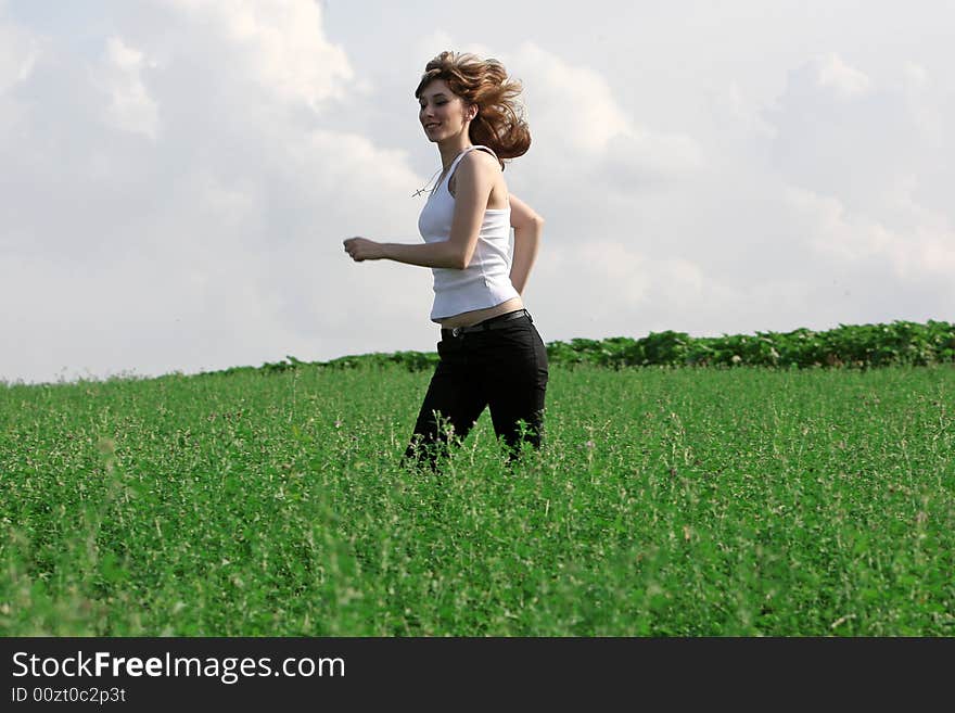 A beautiful girl running on the field