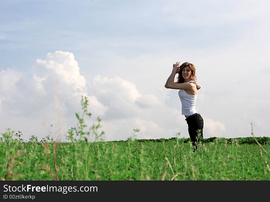 A beautiful girl jumping on the field