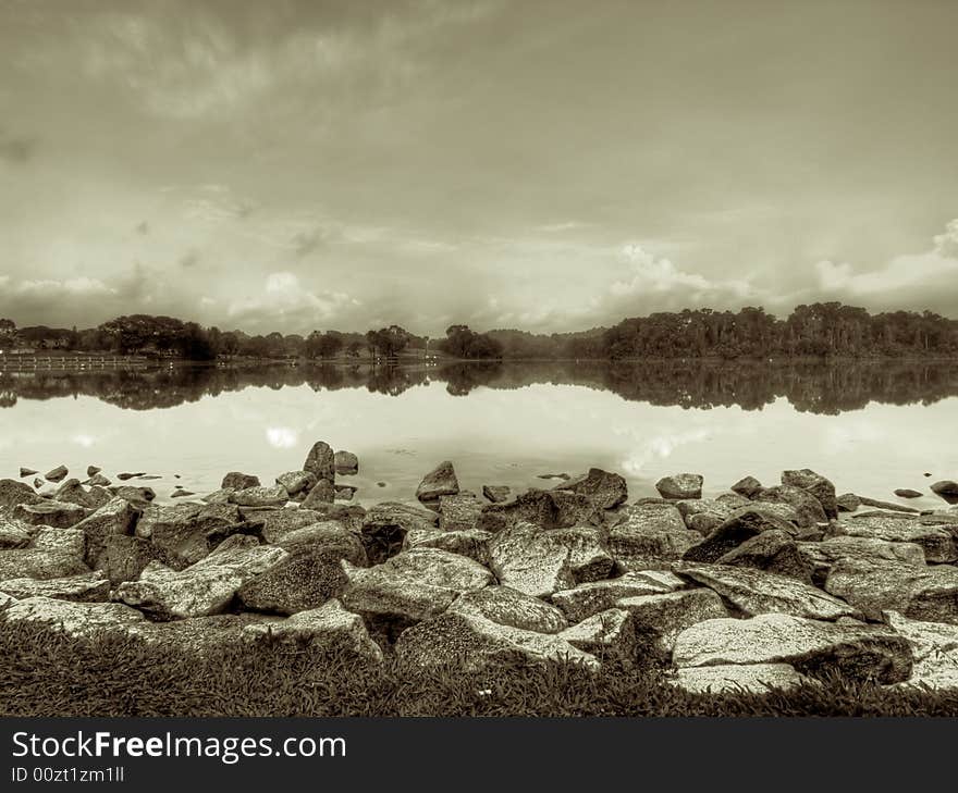 Rocky shore of a reservoir in black and white