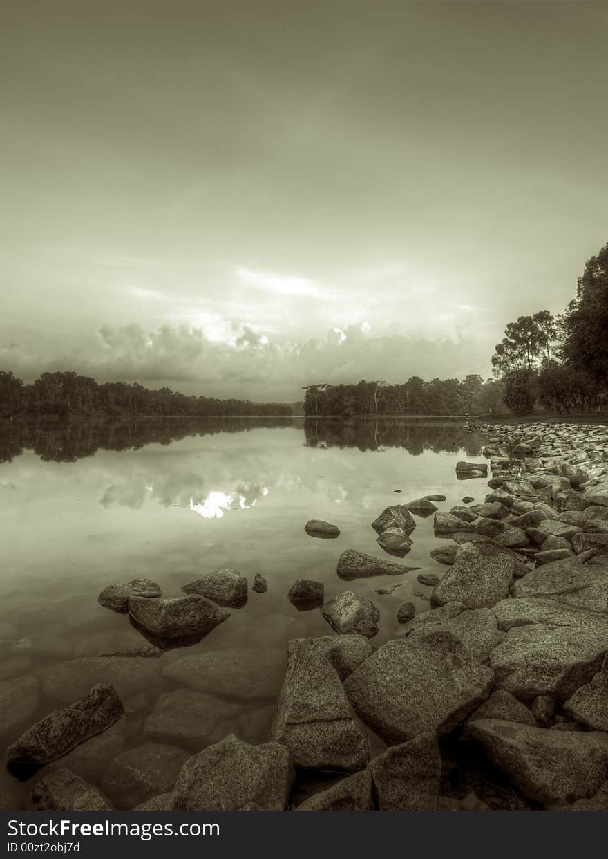 Rocky shore of a reservoir in black and white