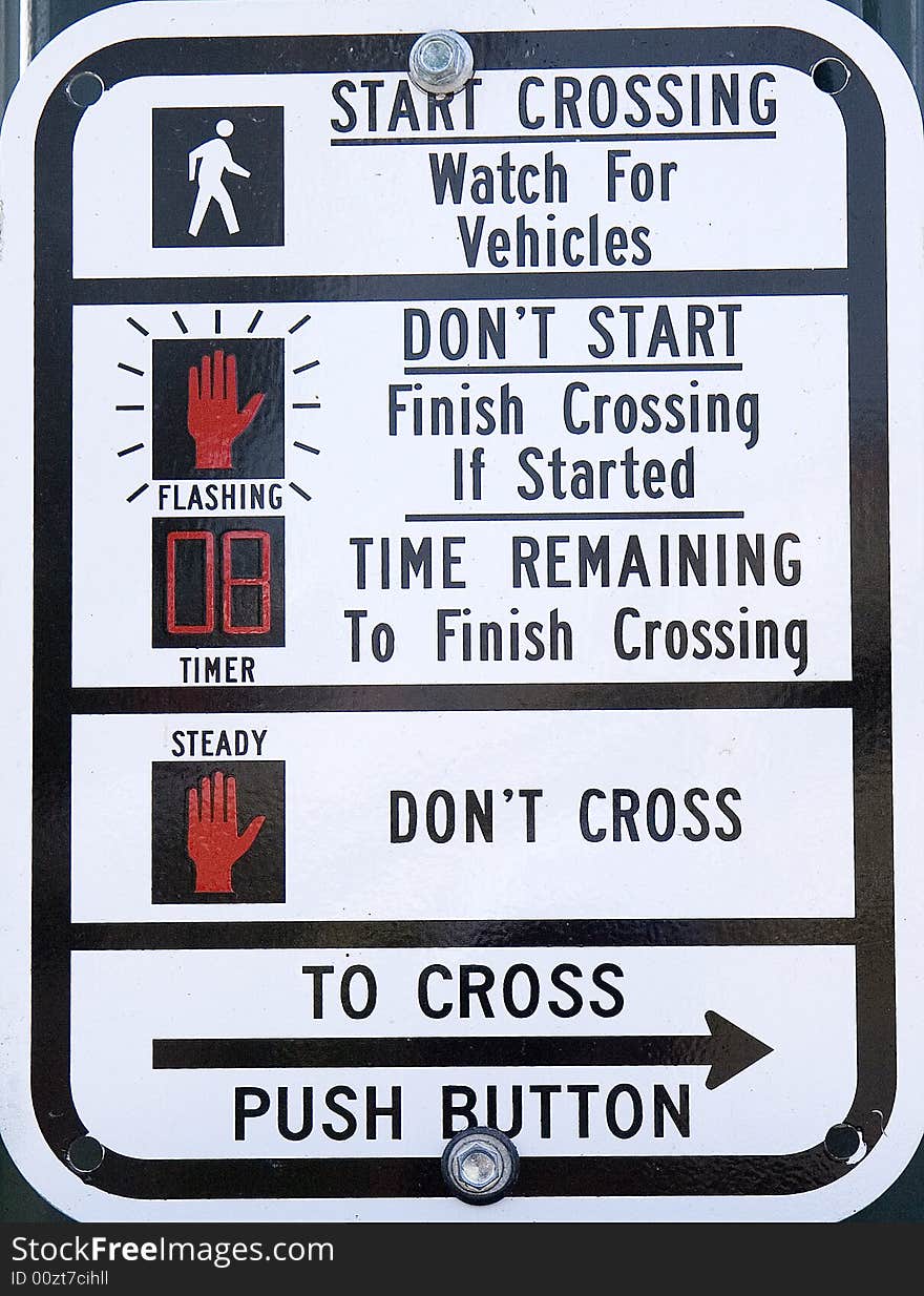 Street sign at a busy crosswalk. Street sign at a busy crosswalk