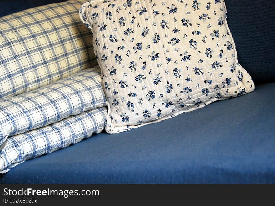 Blue and white cushions with flowers and lines