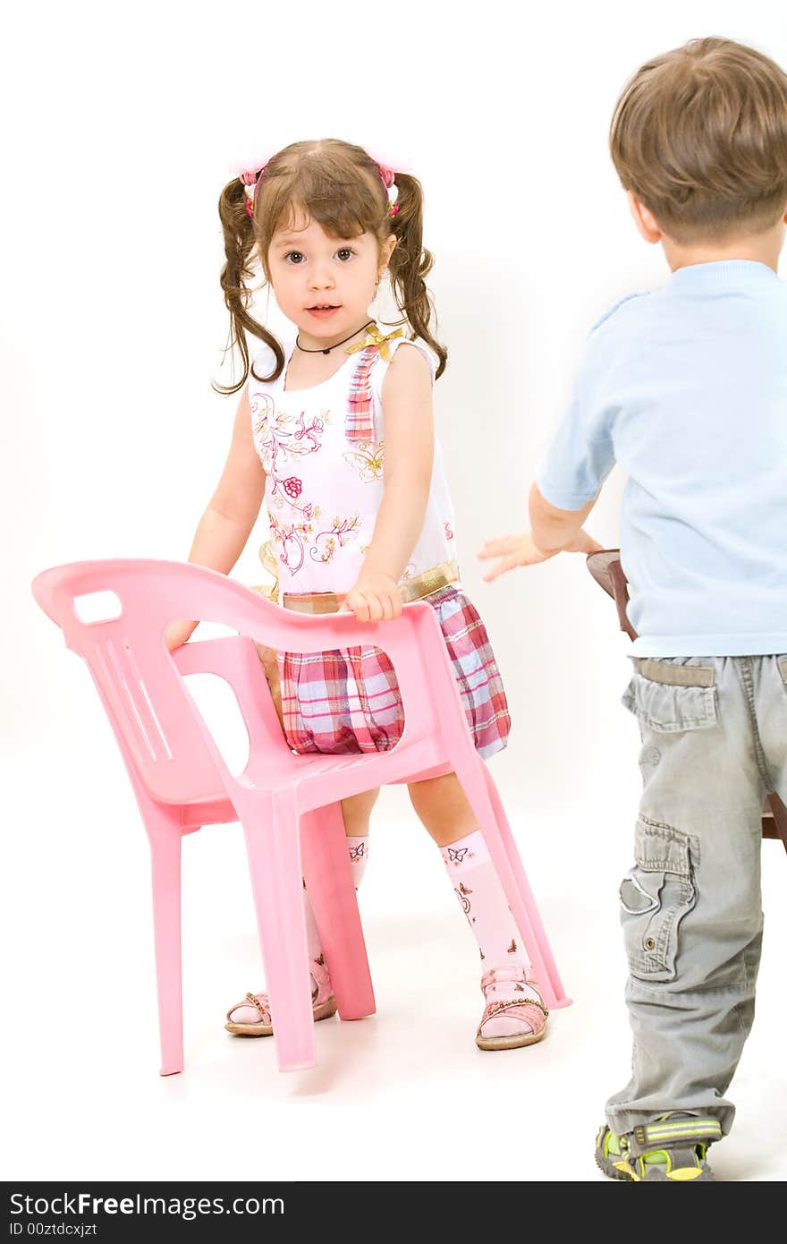 Cheerful little children with pink chair isolated over white. Cheerful little children with pink chair isolated over white