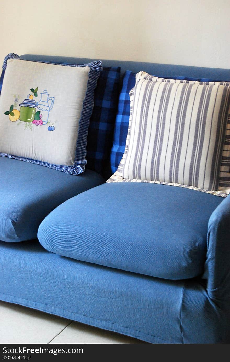 A blue sofa with cushions