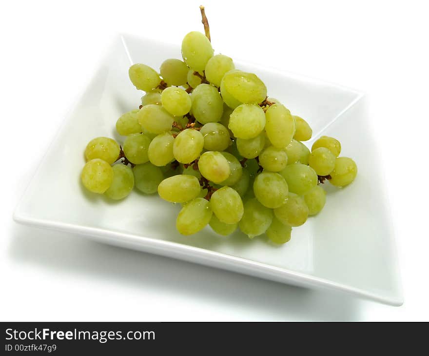 Fresh bunch of green grapes in white bowl and isolated on white background. Fresh bunch of green grapes in white bowl and isolated on white background