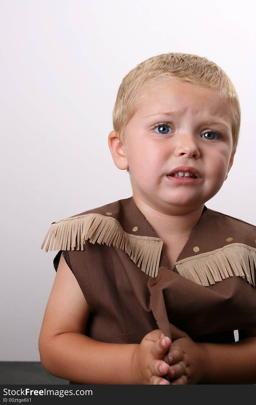 Toddler wearing a cowboy shirt with brown fringing