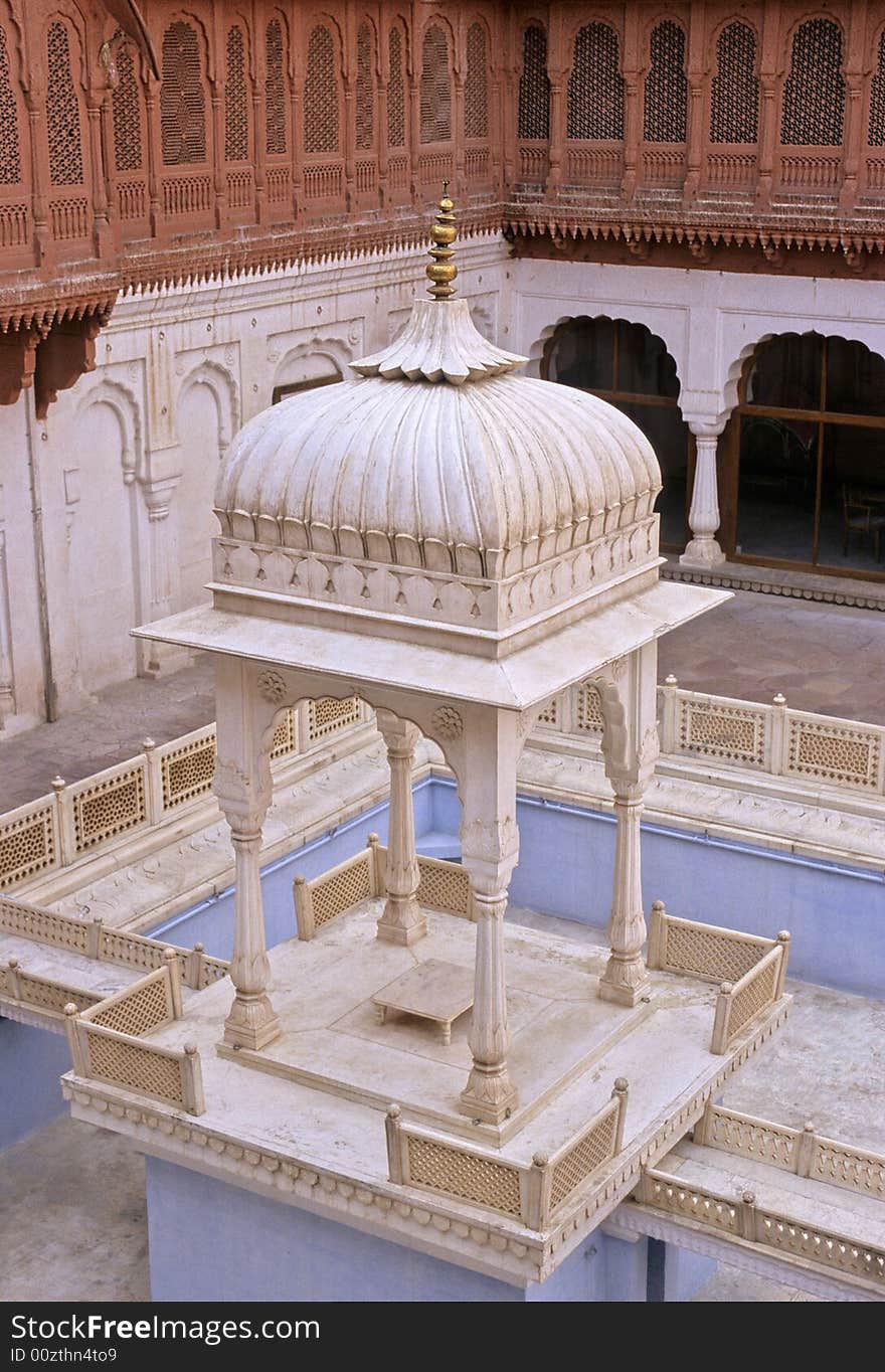 White marble dome, fully engraved, supported by four pillars over a basin in Junagarh palace, Bikaner, Rajasthan, India. White marble dome, fully engraved, supported by four pillars over a basin in Junagarh palace, Bikaner, Rajasthan, India.