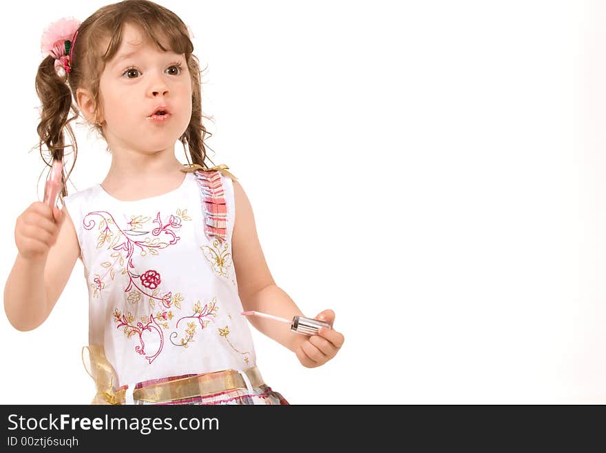 Adorable little girl applying make-up