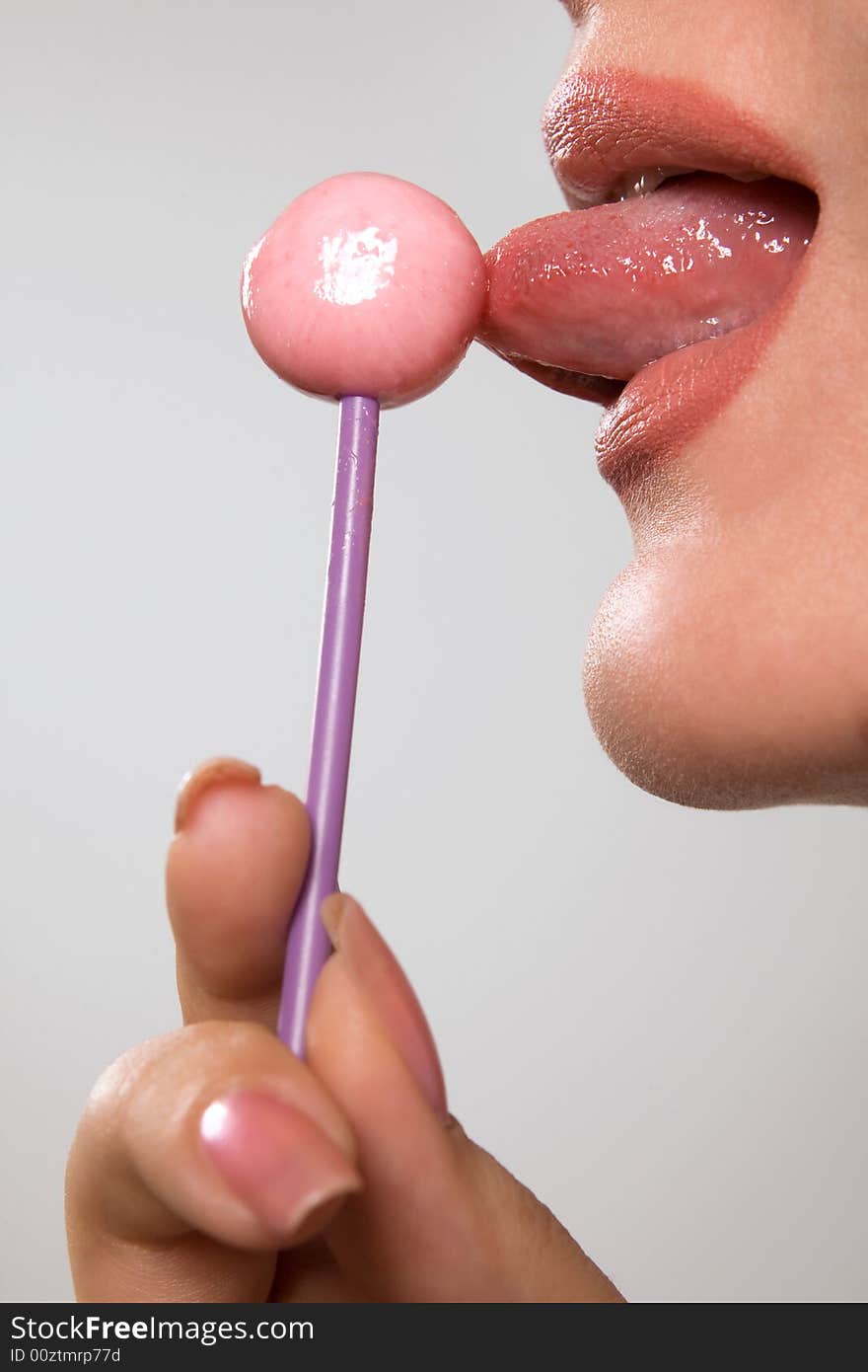 Young beautiful girl with lollipop